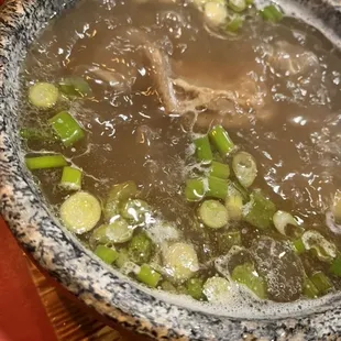 Pho soup in stone bowl.