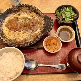 a bowl of rice, a bowl of vegetables, and a bowl of soup