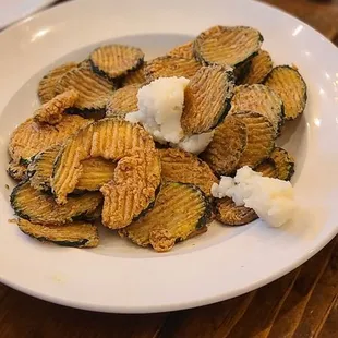 a plate of fried zucchini chips