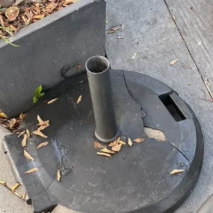 Empty umbrella stands, like the one my waiter tripped on, peppered throughout the patio