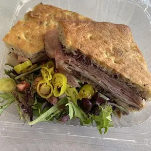 Godfather:  Focaccia bread, salami, prosciutto, roasted peppers, olive tapenade spread  Comes with an Italian Side Salad!