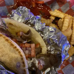 Gyro and fries half eaten.