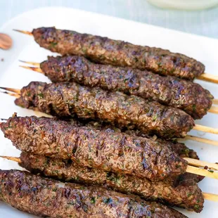 skewered meat on a white plate