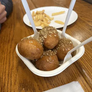 Loukoumades - Greek donuts, fried fresh and covered in honey, walnuts and cinnamon