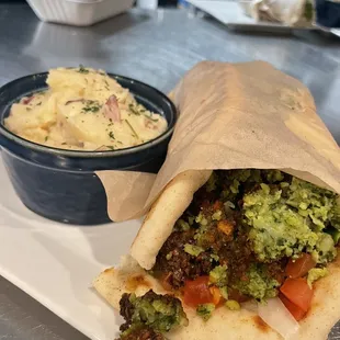 Falafel Wrap   Ground chickpeas in our special blend of herbs and spices, tzatziki, lettuce, onion, tomato With garlic mashed potato's