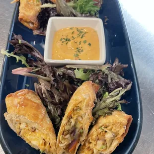 Gyrolls  Eggrolls filled with hand sliced gyro meat, Sriracha slaw, mozzarella and feta cheese served with eggroll sauce Greek