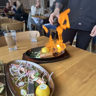 a person cooking food on a grill