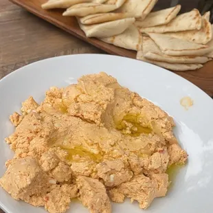 a plate of hummus and pita chips