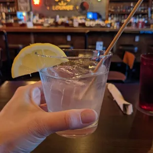 a person holding a glass of alcohol