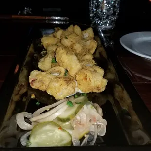 Perfectly cooked Calamari with pickled cucumber and baby onions