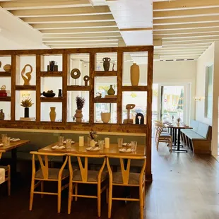 a dining room with wooden tables and chairs
