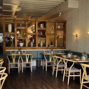 a restaurant with wooden tables and chairs