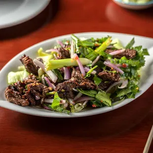 a plate of food with chopsticks