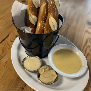 a bowl of pretzels and dipping sauce