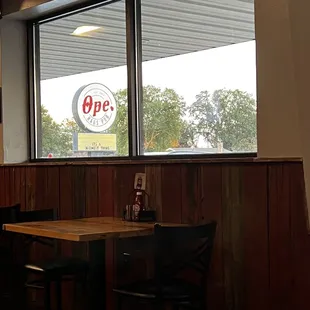 Ope Haus Pub sign viewed through window