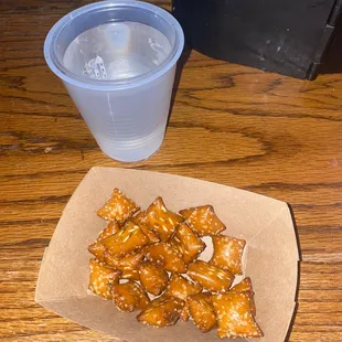 a plate of chicken wings and a cup of water