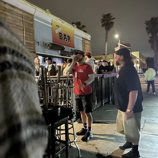 a crowd of people standing outside at night