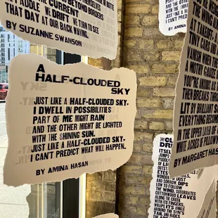 a bunch of torn paper on a brick wall