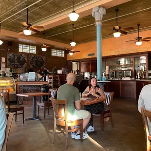 people sitting at tables in a restaurant