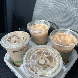 four cups of iced coffee on a tray