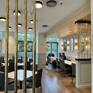 a dining area with tables and chairs
