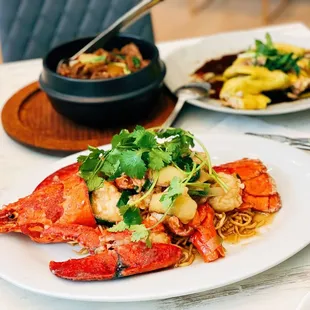 a plate of lobster and a bowl of soup