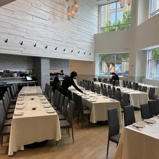 a large dining room with tables and chairs