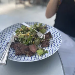 a plate of steak and salad
