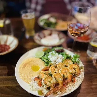 Grilled tiger shrimp with a glass of wine.