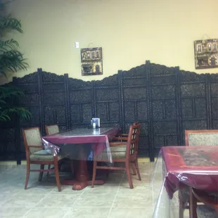 a dining area with tables and chairs