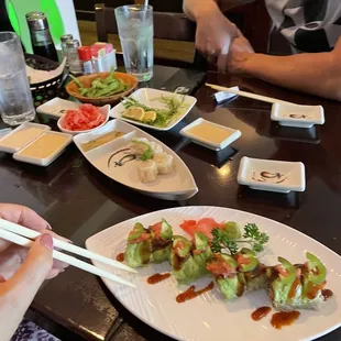 a person eating sushi with chopsticks