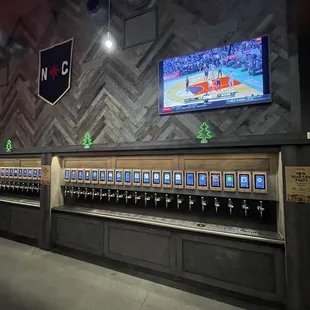 a row of beer taps in a sports bar