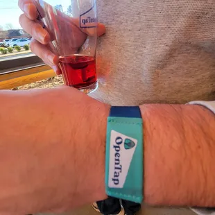 a person holding a glass of red wine