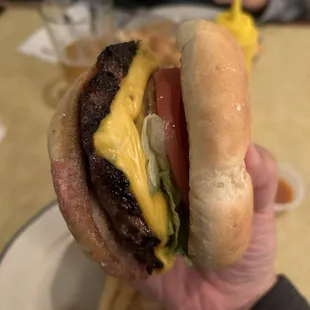 cross section of char burger with cheese with all the fixins