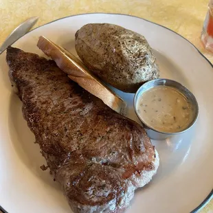 special 14oz ny strip with bourbon sauce with baked potato and garlic bread