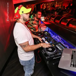 a dj mixing in front of a laptop