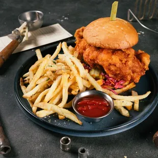 a fried chicken sandwich with fries and ketchup