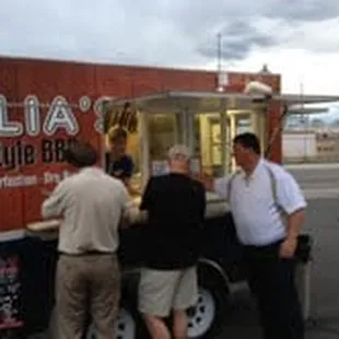 three men ordering food from a food truck