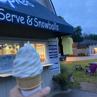 a hand holding an ice cream cone