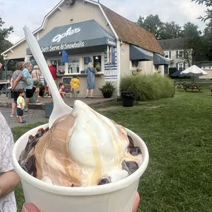 a person holding a cup of ice cream