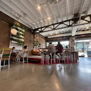 people sitting at tables in a coffee shop