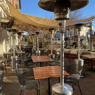 Outdoor patio dining with fans and heaters