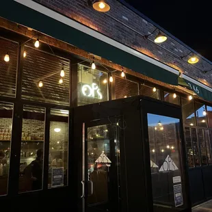 the outside of a coffee shop at night