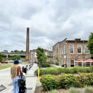 a woman walking with a stroller