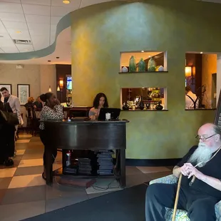 a man with a long beard sitting in a chair