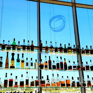 bottles of alcohol on a glass shelf