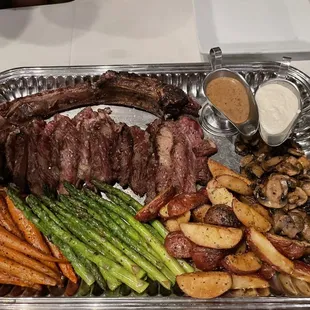 Tomahawk Ribeye. Carrots, asparagus, potatoes and mushrooms. More than enough for two people. Gravy and a horseradish sauce.