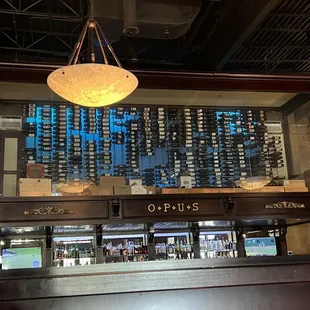 Chilled wine room above and behind the bar with twisted stairs access.