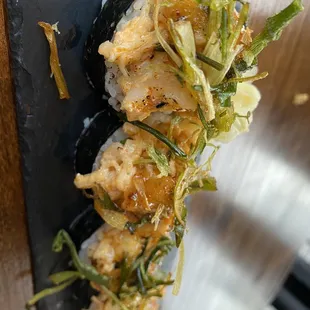 a sushi roll on a black plate