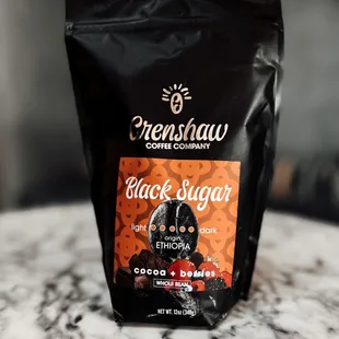  bag of black sugar on a marble table